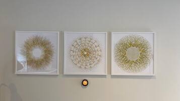 Three framed artworks on a wall.