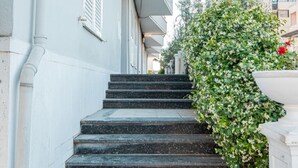 A set of stone steps leading up to a building with white walls and shutters. - Lovely 2-bedroom apartment with sea view in Durrës (Durrës)