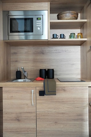 Mini-fridge, microwave, stovetop, cookware/dishes/utensils