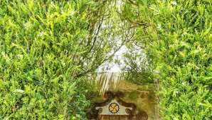 A mosaic wall with geometric patterns and a heart symbol.