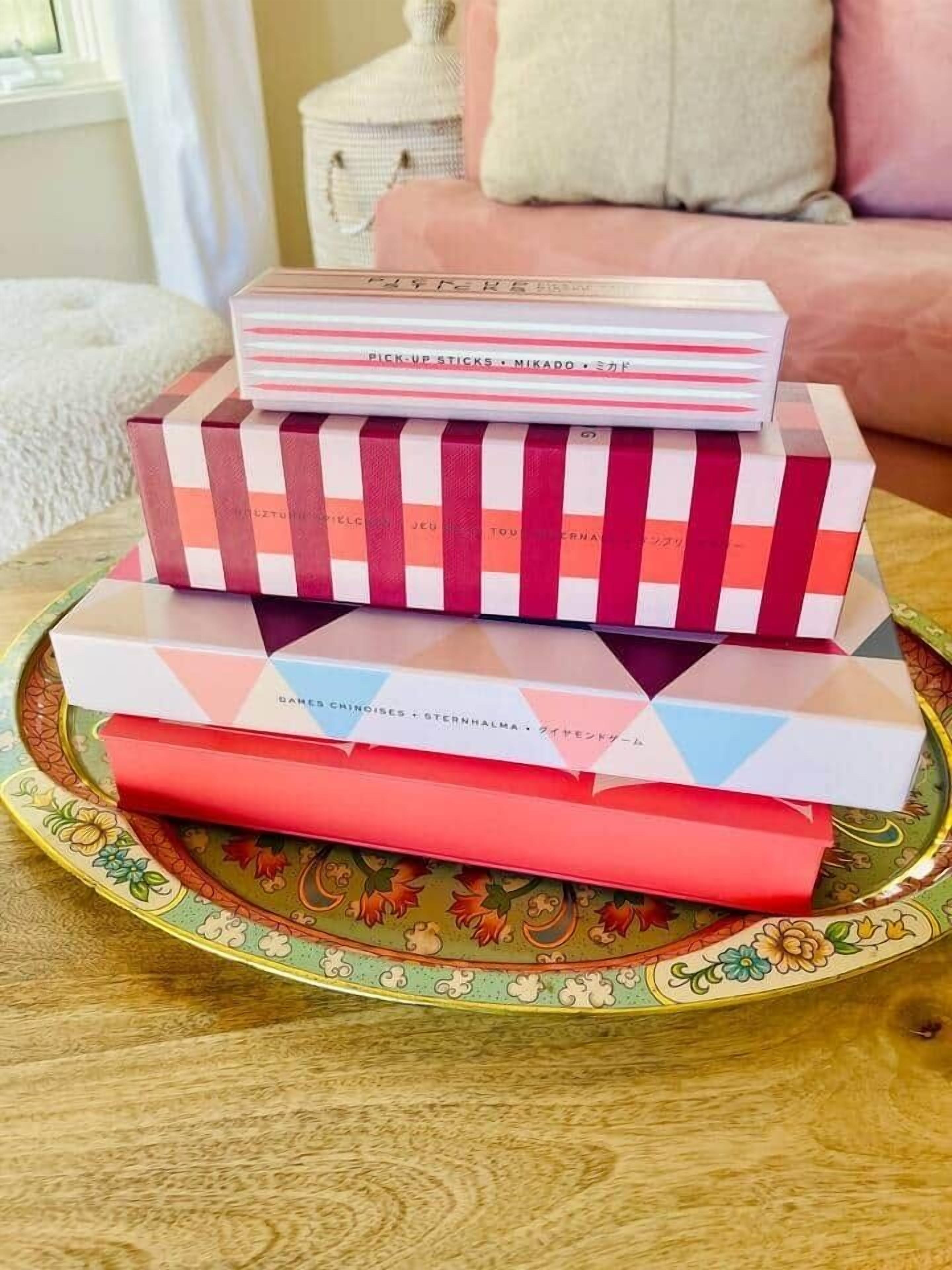 A stack of colorful boxes on a decorative tray.