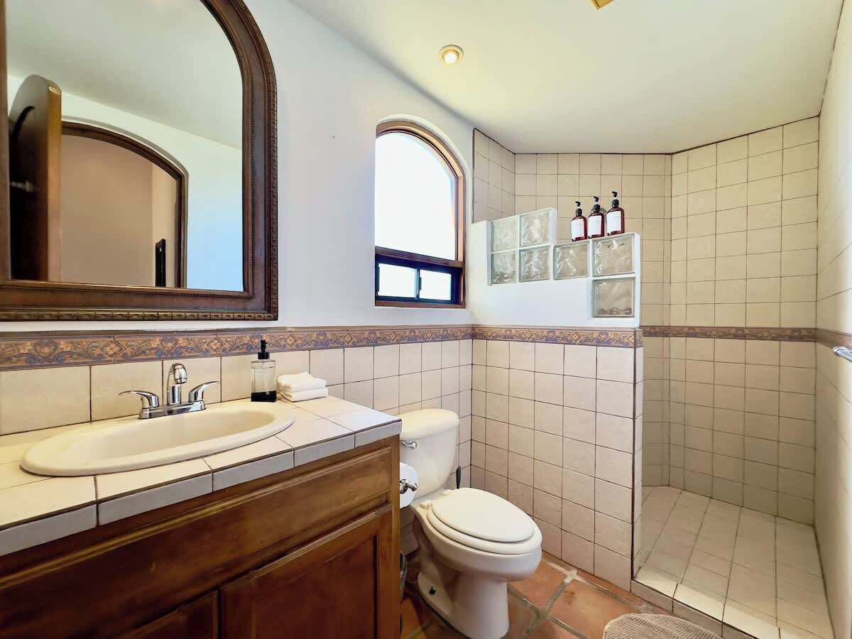 Een badkamer met een wastafel, toilet en douche.