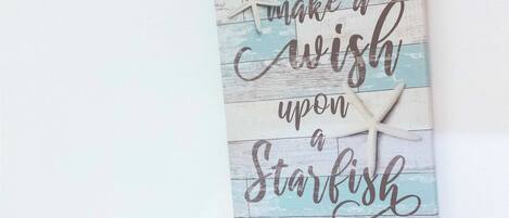 A wall decoration with a starfish and text.