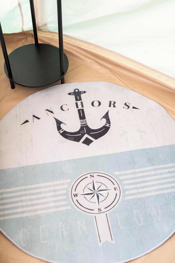 A circular wall decor with nautical-themed anchor and compass designs, and the words 'ANCHORS' and 'CLEAN LOVE' visible.