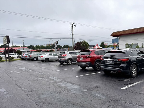 A parking lot with multiple cars parked in designated spaces.