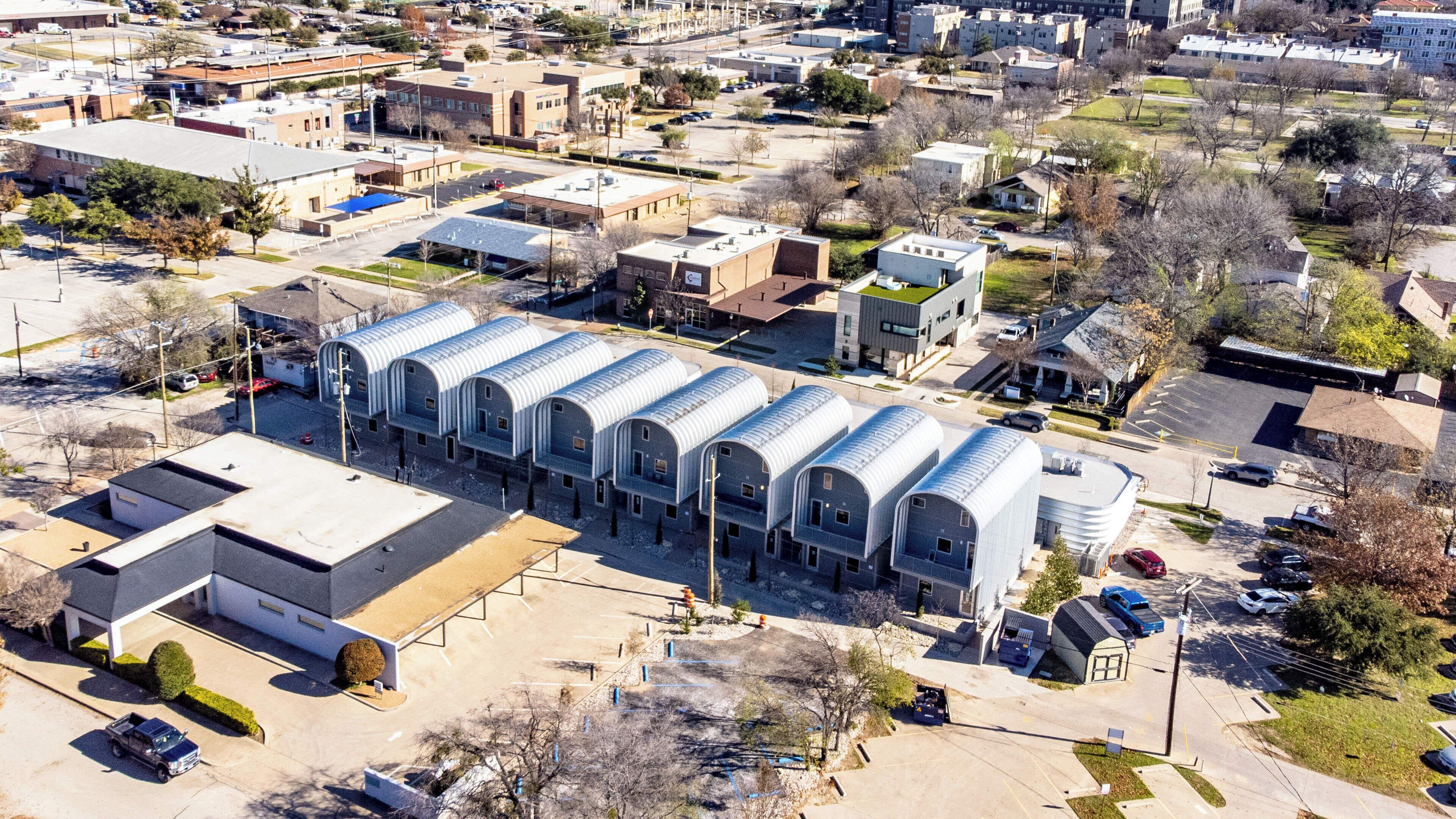 An aerial view of a commercial building with a row of large, arched structures.