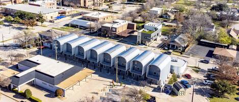 An aerial view of a commercial building with a row of large, arched structures.