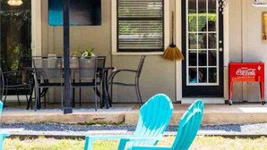 A building with a Coca-Cola sign, outdoor seating with chairs, and a door. - Canyon Lake Retreat by The Key Rentals (Canyon Lake)
