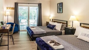 A hotel room with two beds, a desk, and a chair. - Canyon Lake Retreat by The Key Rentals (Canyon Lake)