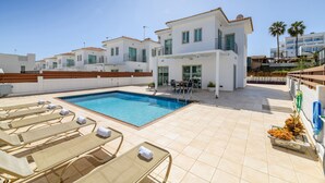 A rooftop pool area with lounge chairs and a pool. - Sunrise Bay Villa 1 (Paralimni)