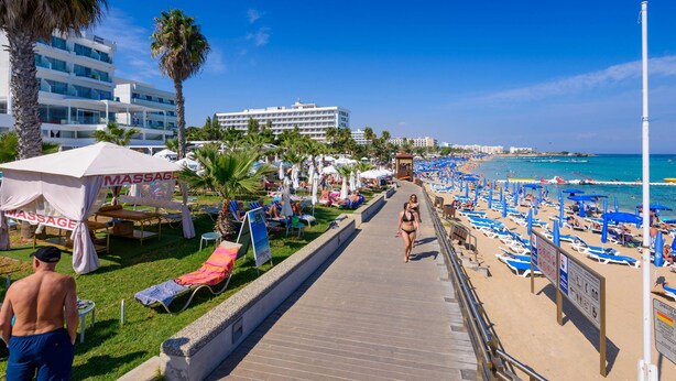 A beachside promenade with sun loungers, umbrellas, and a massage tent. - Mylos Lifestyle Seaview Villa 21 (Paralimni)