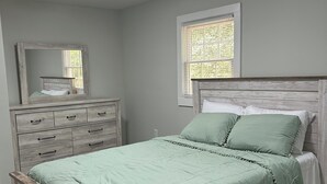 A bedroom with a bed, dresser, and a window. - 3-bedroom house in marvelous Athens (Athens)