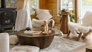 A cozy cabin interior with a stone fireplace, a wooden ceiling, and a large window. - Fox Den|Sauna|BBQ|LakeAccess|PrivateBeach|Firepit (Huntsville)