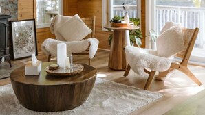 A cozy living room with wooden walls, a fireplace, and a large window overlooking a deck. - Fox Den|Sauna|BBQ|LakeAccess|PrivateBeach|Firepit (Huntsville)
