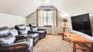 A cozy living room with a sectional sofa, a wooden coffee table, and a flat-screen TV. - 10 Mi to Mobile Bay: Family Apt in Silverhill! (Silverhill)
