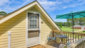 A small, single-story building with a sloped roof, a door with a window, and a welcome mat. - 10 Mi to Mobile Bay: Family Apt in Silverhill! (Silverhill)
