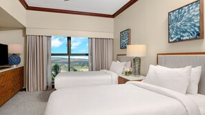 A hotel room with two beds, a TV, a dresser, a window with curtains, and artwork on the walls.