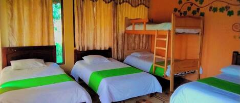 A room with three single beds, a bunk bed, and a ladder.