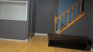 A room with a built-in bench, a staircase, and a large window. - A min walk to the zoo and University!2 bed apartment (Peterborough)