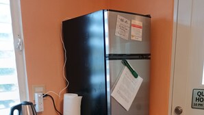 A kitchen with a refrigerator, a kettle, a microwave, a dishwasher, and a sink. - BioBay Inn Apt C - Cute Tiny Studio w/wifi & AC Near Malecon, Sun Bay (Vieques)