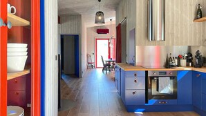A modern kitchen with blue cabinets, a wooden countertop, and a built-in oven. - 2 bedroom cozy home in Lärbro (Lärbro)
