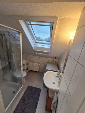 Shower, hair dryer, towels, toilet paper