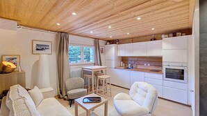 A compact living space with a kitchen, dining area, and seating.