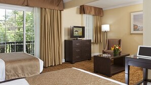 A hotel room with two beds, a television on a dresser, a desk with a laptop, a chair, and a window with curtains. - 2 Spacious Room with Free Breakfast, Heated Pool & Parking Near Stanford (Palo Alto)