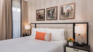 A hotel room with a large bed, two bedside tables with lamps, and three framed pictures on the wall. - Beautiful Boutique Room with Breakfast, Near Fisherman’s Wharf & Golden Gate (San Francisco)