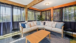 A room with a sectional sofa, a wooden coffee table, and a small side table.
