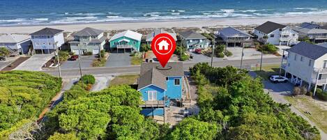 Zona residencial à beira-mar, com casas, praia e um marcador de localização.