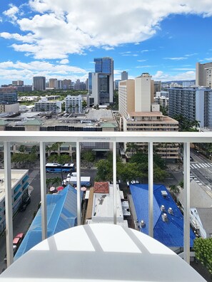 A cityscape with modern buildings, a clear sky, and a view of the streets below.