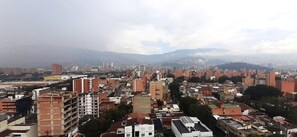 A densely packed urban area with numerous buildings, including high-rise apartments and commercial structures. - Penthouse Rooftop  Gem in the Laureles (Medellín)