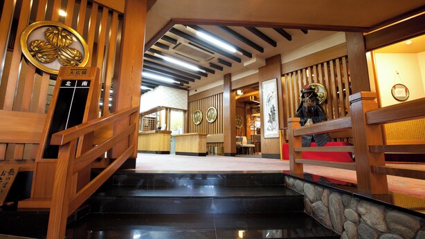 A wooden staircase with a stone wall at the bottom. - Hitomarukadan (Akashi)