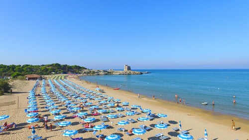 Property In A Holiday Village 'Monolocale Con Giardino' with Shared Pool and Air Conditioning