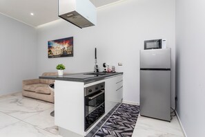Eine moderne Küche mit Kochinsel, Backofen, Mikrowelle und Kühlschrank.