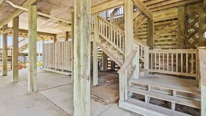 A wooden staircase leading to a covered area with a view of the water. - 8330 Mariah*DogFriendly*Hot tub*SoundViews* (Avon)