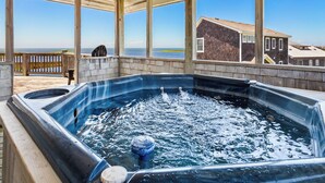A hot tub with a view of the ocean, wooden deck, and a house in the background. - 8330 Mariah*DogFriendly*Hot tub*SoundViews* (Avon)