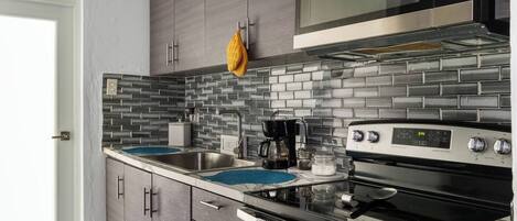 Fridge, stovetop, coffee/tea maker, cookware/dishes/utensils