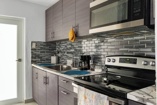 Fridge, stovetop, coffee/tea maker, cookware/dishes/utensils