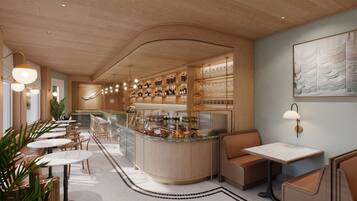 Un intérieur moderne avec un bar central, des espaces aménagés pour s’asseoir et un élément décoratif mural.