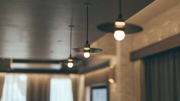 A modern interior with pendant lighting and large windows.