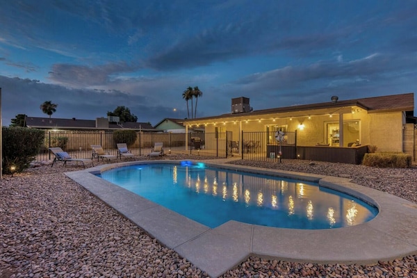 Large private backyard with heated swimming pool