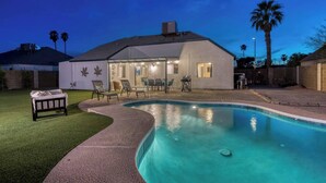 A house with a swimming pool, outdoor seating, and a covered patio area. - Blue Oasis with Private Heated Pool at NO COST (Tempe)