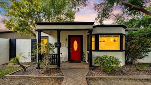 A building with a red door, a small porch, and a sign with the number 1456. - Fabulous entertainers Paradise! Pool & Spa (Phoenix)