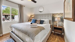 A bedroom with a bed, a ceiling fan, a nightstand, and a window with curtains. - PRIVATE OASIS with the BEST backyard!!! (Phoenix)