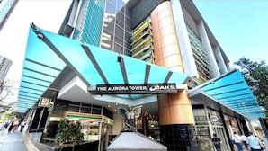 The Aurora Tower with a prominent entrance and a statue. - Arcade In The Sky- Views, Games & Vibes (Brisbane City)