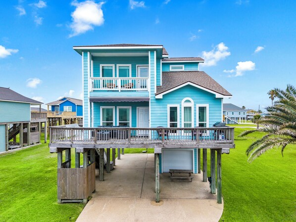 A two-story house with a balcony, a covered porch, and a small deck.