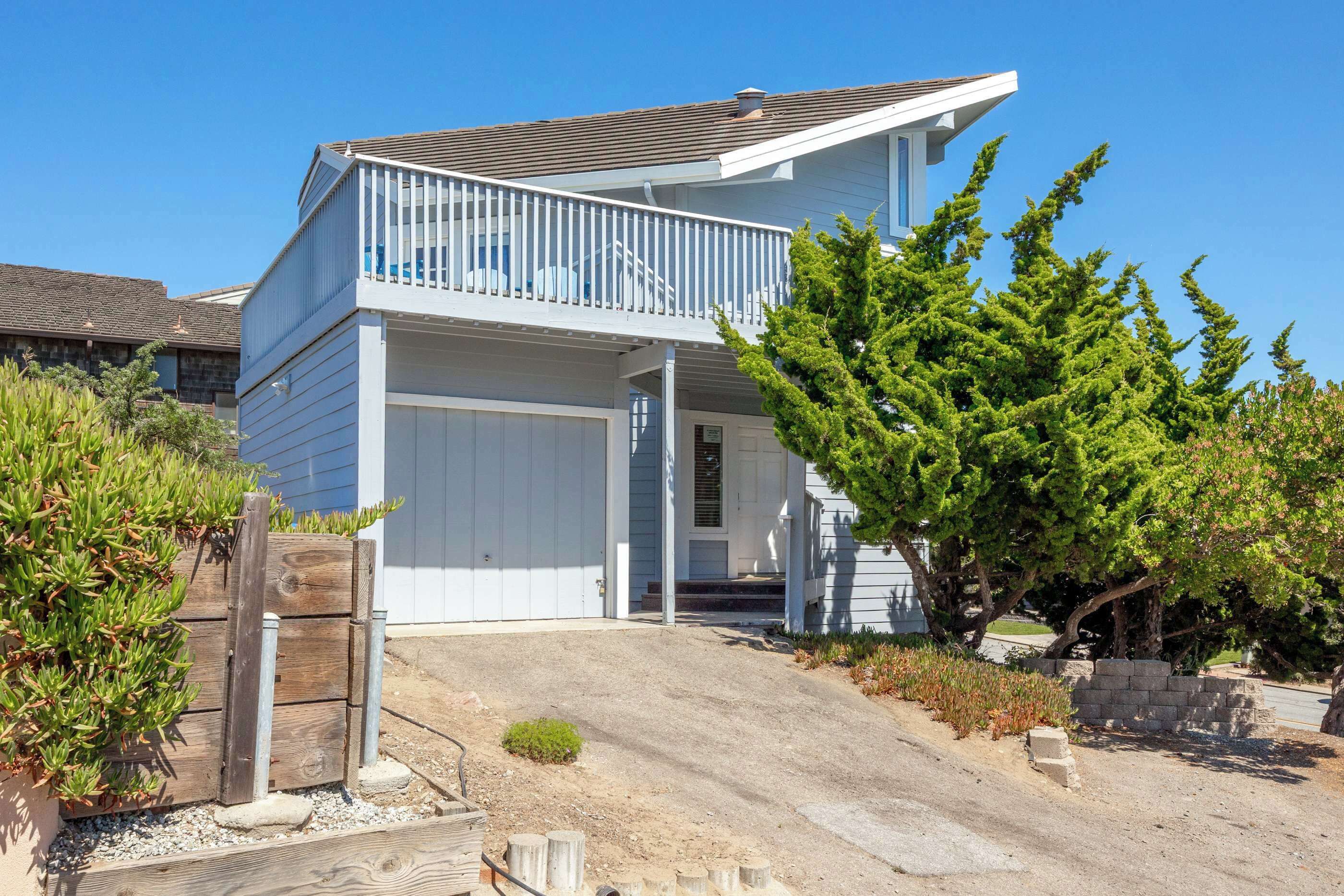 A two-story house with a front porch and a garage.
