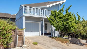 A two-story house with a front porch and a garage.